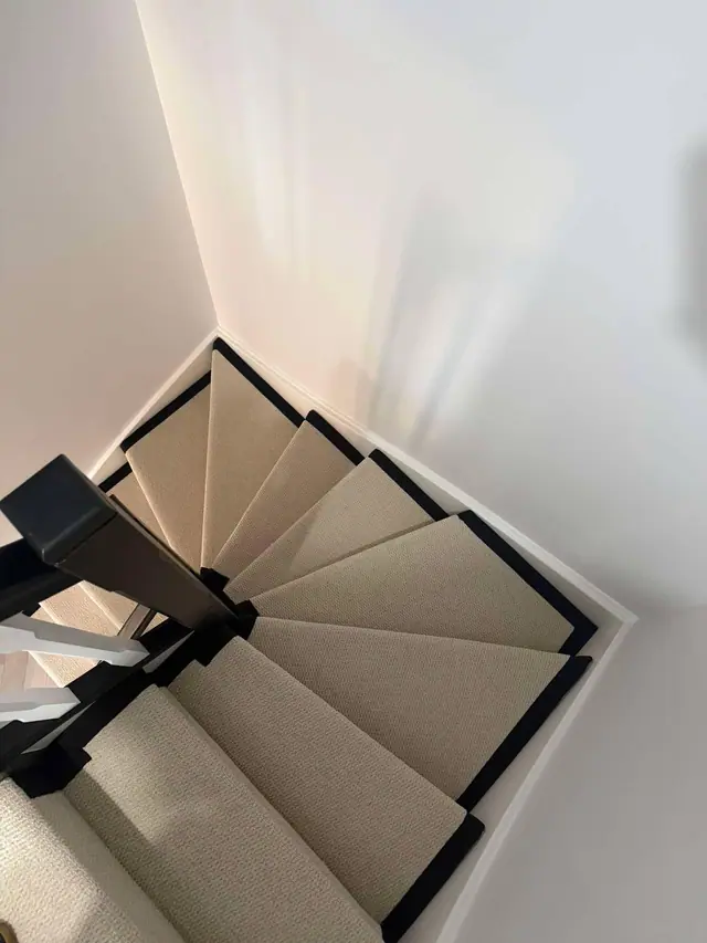 Neutral runner with dark edging on a turning staircase