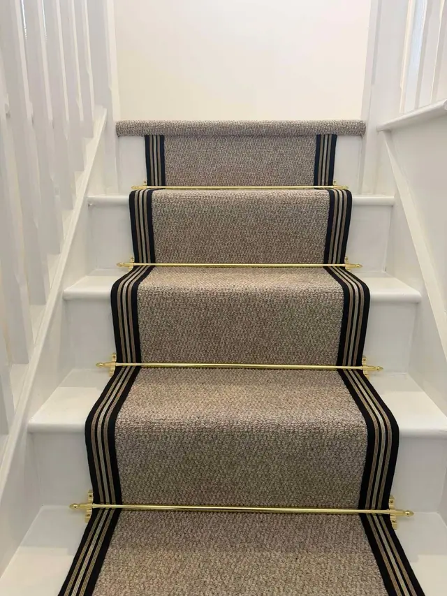 Striped runner secured with stair rods