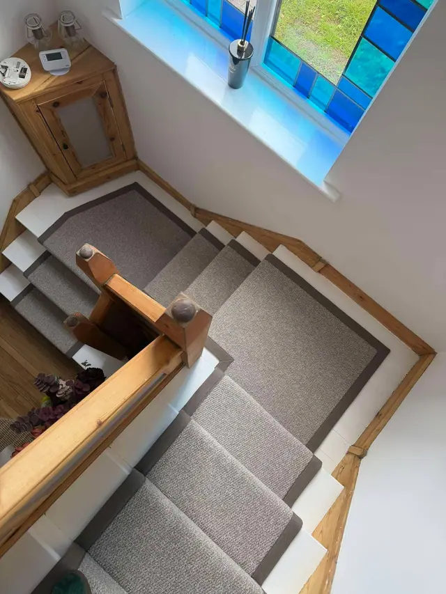 Grey runner on winding stair treads