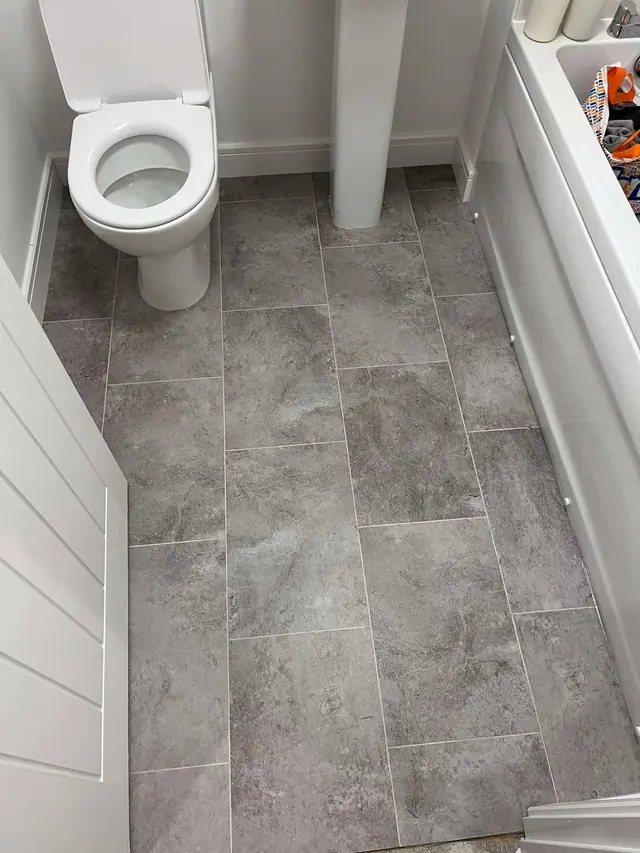 Grey stone-effect LVT in a bathroom
