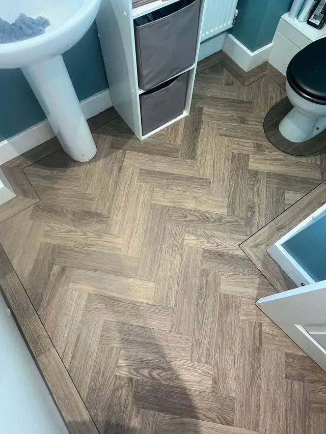 Wood-effect herringbone LVT in a bathroom