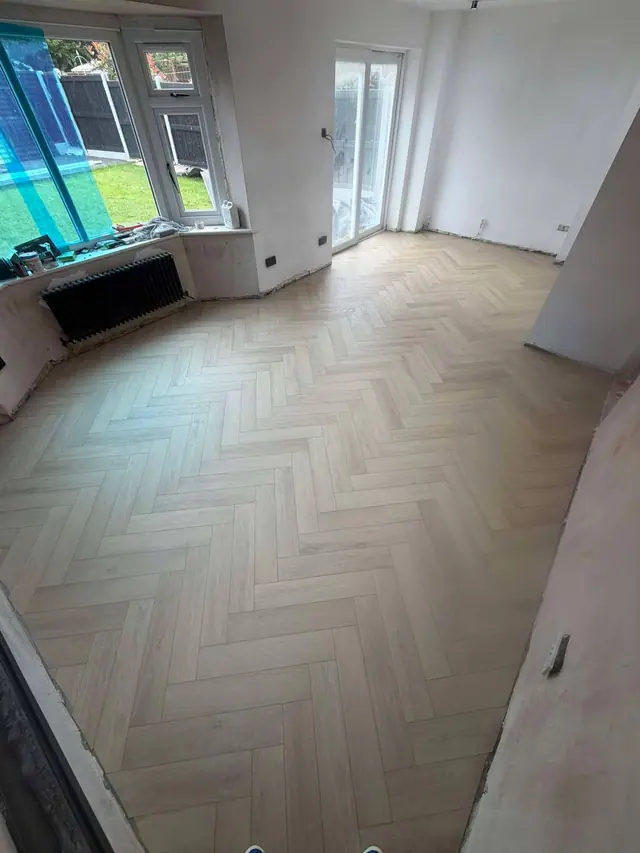 Pale herringbone LVT across an open room