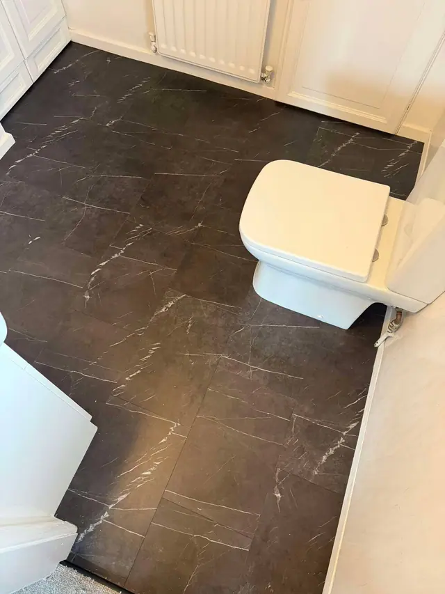 Dark marble-effect LVT in a cloakroom