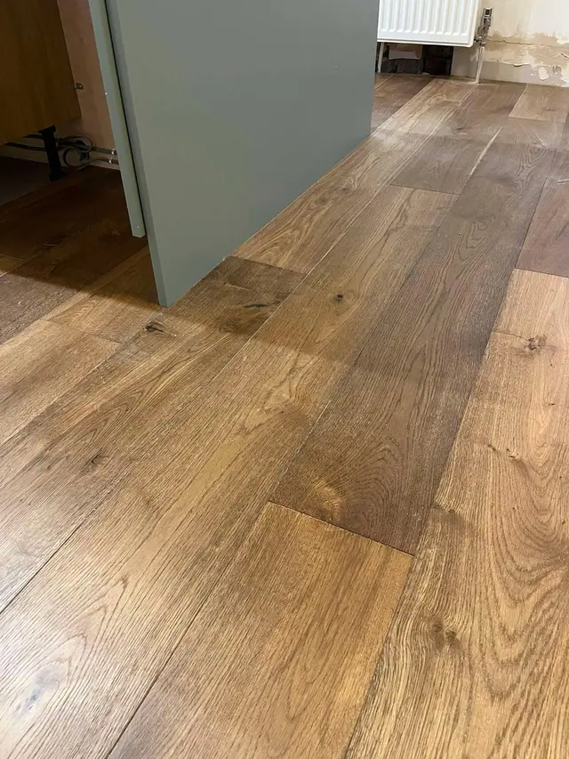 Real wood planks beside a kitchen island