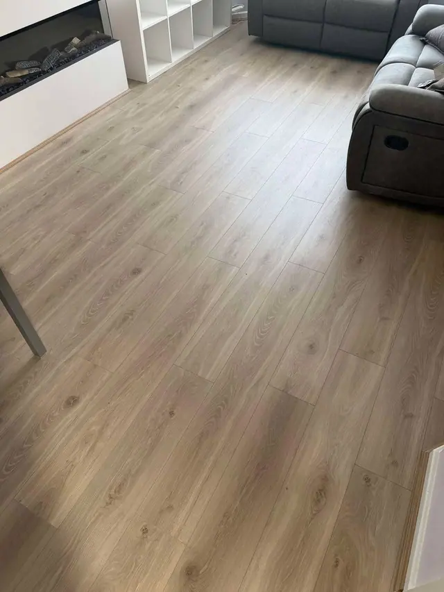 Light laminate beside a contemporary fireplace