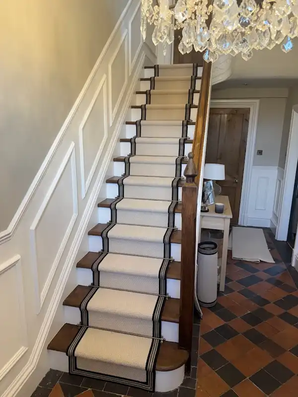 Bordered stair runner with stair rods