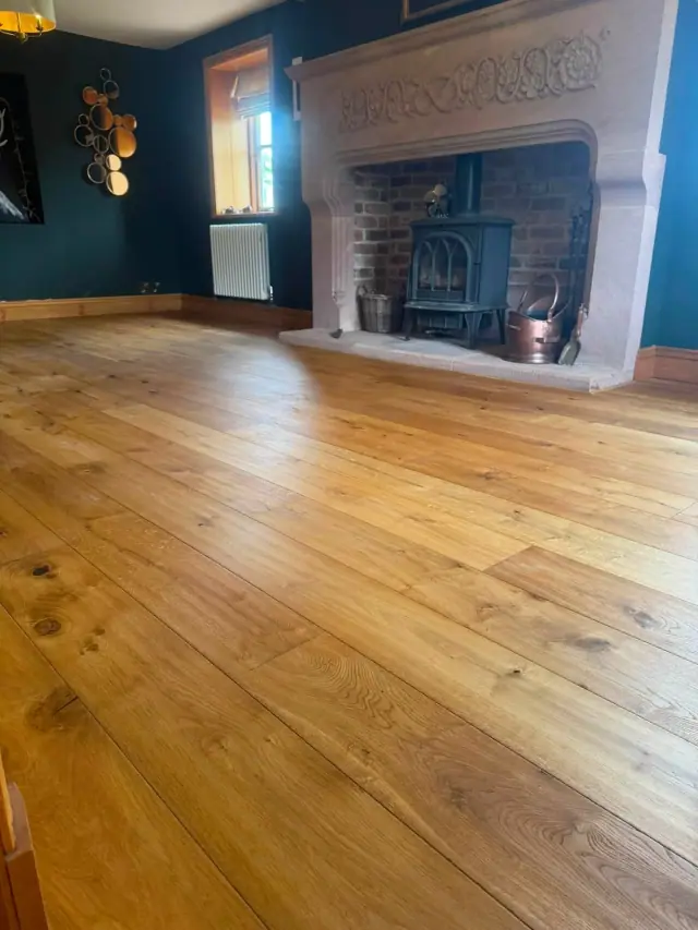 Real wood flooring beside a fireplace