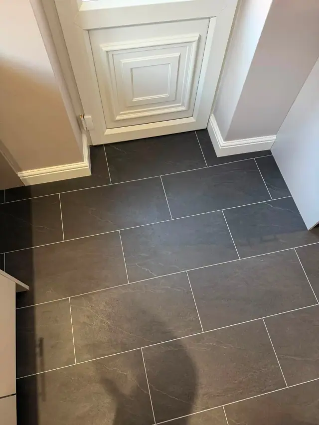 A dark tile-effect hallway