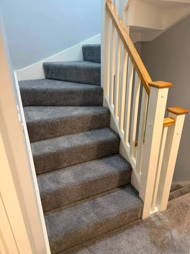 Grey carpet on a turning staircase