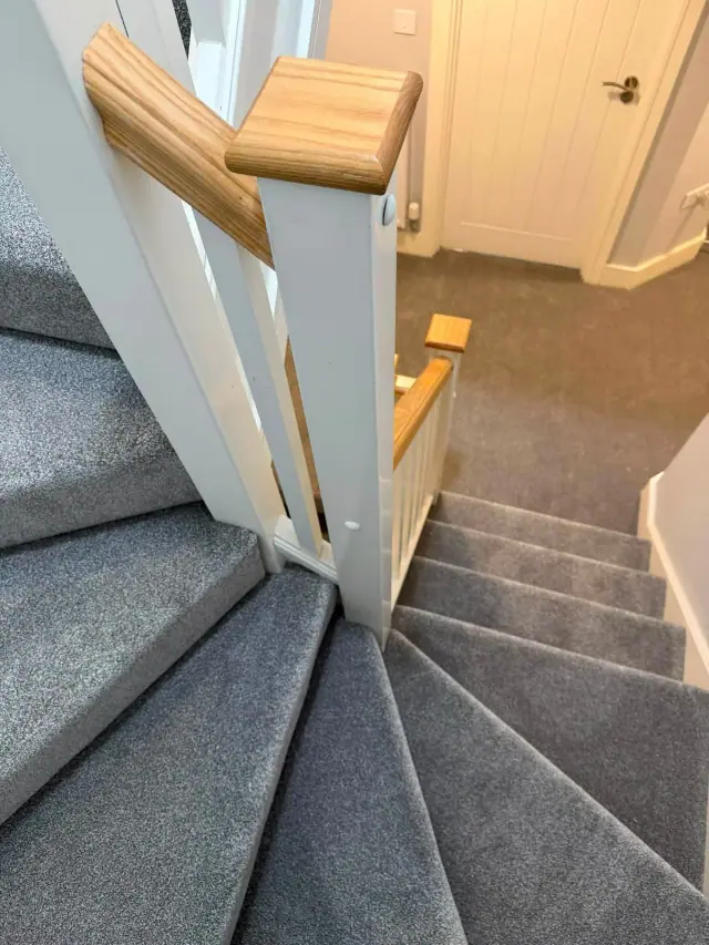 Carpet flowing from stairs to landing